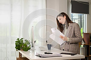 Caucasian businesswoman checking investment reports working online from home office