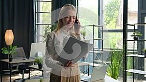 Caucasian businesswoman happy young woman girl business lady talk mobile phone at office hold papers contract discuss