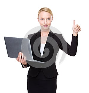 Caucasian businesswoman with laptop and thumb up