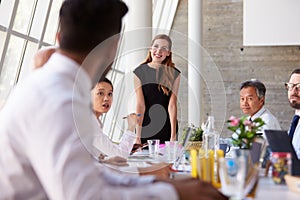 Caucasian Businesswoman Leading Meeting At Boardroom Table