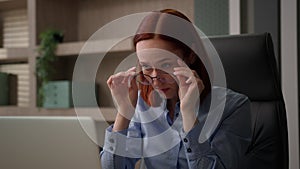 Caucasian businesswoman in office work with computer laptop confused with blurry vision business woman female worker