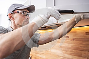 Caucasian Cabinetmaker Assembling Kitchen Cabinets