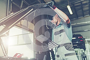 Caucasian Car Mechanic Electronic Elements Technician Checking on an Issue