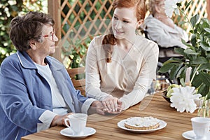 Caucasian caretaker talking to woman