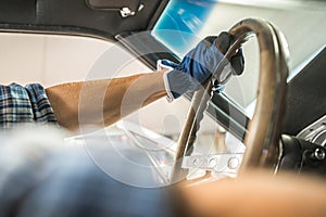 Restoration Mechanic Behind Classic Car Steering Wheel