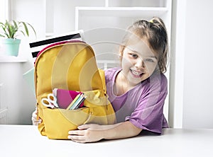 Caucasian child girl portrait with backpack.Back to school concept,school supplies