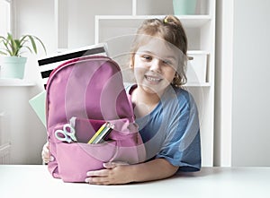 Caucasian child girl portrait with backpack.Back to school concept,school supplies.Schoolbag and pupil