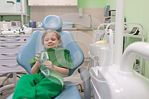 Caucasian child kid sit in dental chair at dentist doctor. Preschooler treating teeth, happy. Concept with copy space