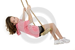 Caucasian child playing on a swing