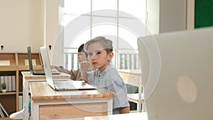 Caucasian child programing software system and learning about coding. Pedagogy.