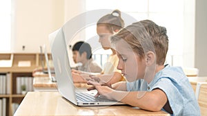 Caucasian child programing software system and learning about coding. Pedagogy.