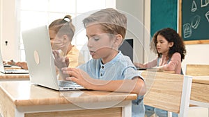 Caucasian child programing software system and learning about coding. Pedagogy.