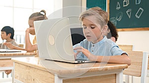 Caucasian child programing software system and learning about coding. Pedagogy.