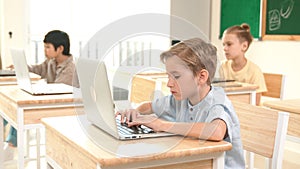 Caucasian child programing software system and learning about coding. Pedagogy.