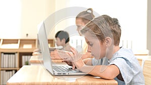 Caucasian child programing software system and learning about coding. Pedagogy.