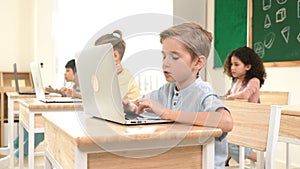 Caucasian child programing software system and learning about coding. Pedagogy.