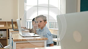 Caucasian child programing software system and learning about coding. Pedagogy.