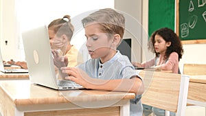 Caucasian child programing software system and learning about coding. Pedagogy.