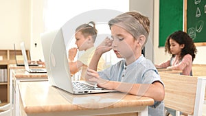 Caucasian child programing software system and learning about coding. Pedagogy.