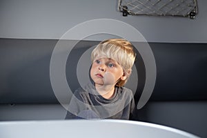 Caucasian child in a train compartment. The passenger travels in the train cabin