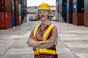 Caucasian Container yard workers woman smile arms crossed standing in container shipyard