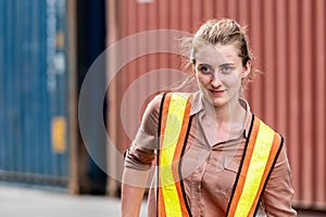 Caucasian Container yard workers woman smile while working in container shipyard