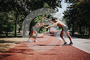 Caucasian couple does cartwheels in a sunny park. Fit and flexible bodies showcase their active lifestyle and motivation