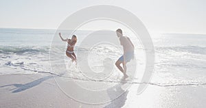 Caucasian couple enjoying time at the beach