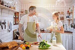 Caucasian couple happy in kitchen together work from home