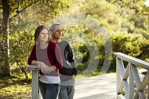 Caucasian couple in love on outdoor wooden bridge