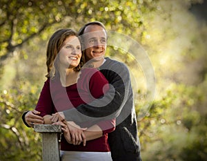 Caucasian couple in love on outdoor wooden bridge