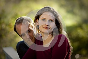 Caucasian couple in love on outdoor wooden bridge