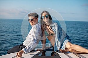 Caucasian couple in love relaxing on yacht bow, Travelling lifestyle concept