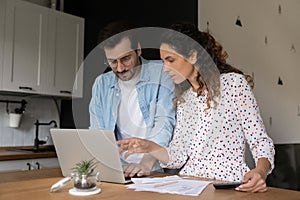 Caucasian couple paying bills on laptop online