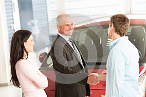 Caucasian couple purchasing a car