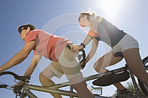 Caucasian Couple Riding Tandem Bicycle