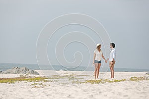 Caucasian couple standing at beach on a sunny day