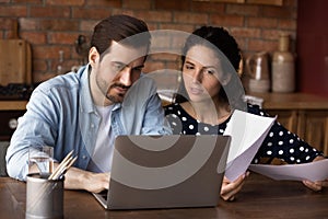 Caucasian couple use computer managing family financial documents