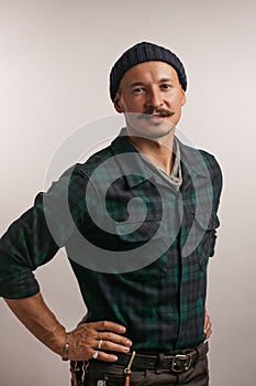 Caucasian craftsman standing confidently with his arms folded isolated over white studio background looking at camera