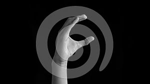 Caucasian deaf human hand forming Asl C alphabet sign isolated on black for easier communication.