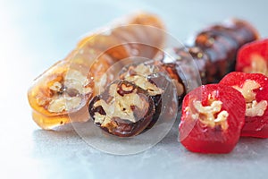 Caucasian delicacy churchkhela with grapes and walnuts on grey background. Traditional eastern cuisine. Traditional