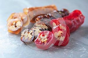 Caucasian delicacy churchkhela with grapes and walnuts on grey background. Traditional eastern cuisine. Traditional