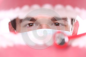 Caucasian Dentist Working Inside a Patient Mouth