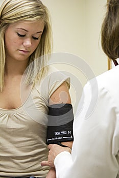 Caucasian doctor examining a teenage female patient