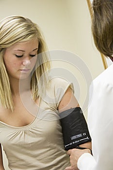 Caucasian doctor examining a teenage female patient