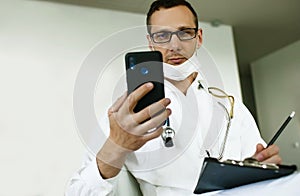Caucasian Doctor Using Cell Phone gives online consultation.