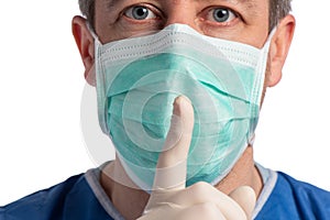 Caucasian doctor wearing a protection mask making a shut up sign on a white background