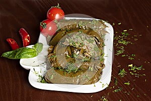 Caucasian dolma is a dish of grape leaves and rice with meat. Serving dolma with yogurt sauce