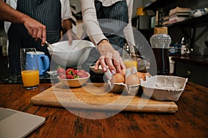 caucasian elderly couple baking in kitchen close up