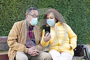 Caucasian elderly couple using a mobile phone